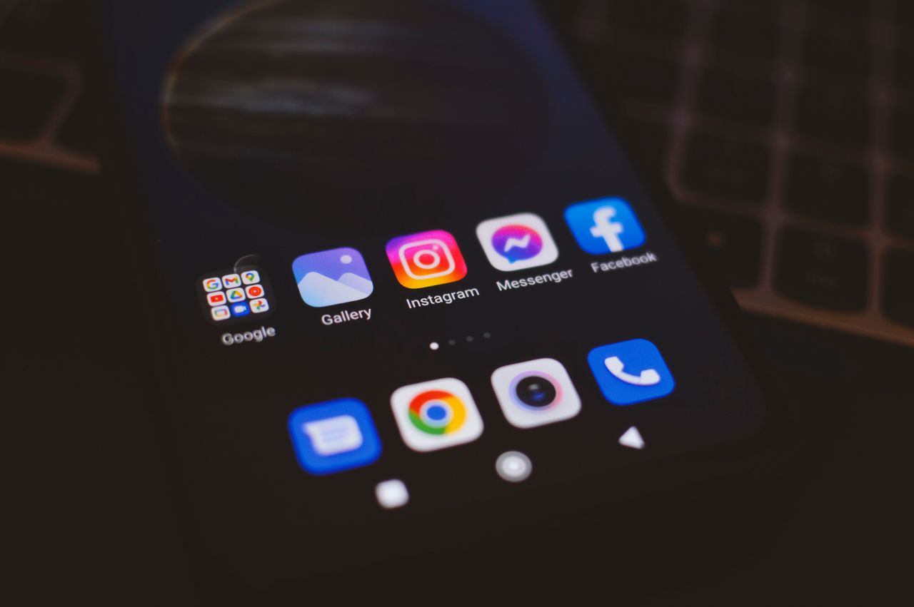 Crafting Captivating Headlines: Your awesome post title goes here A smartphone displaying popular social media apps in a dimly lit environment, perfect for tech and communication themes.